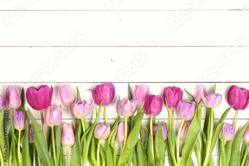 Fototapeta Naklejka Na Ścianę i Meble -  Pink tulips over shabby white wooden table