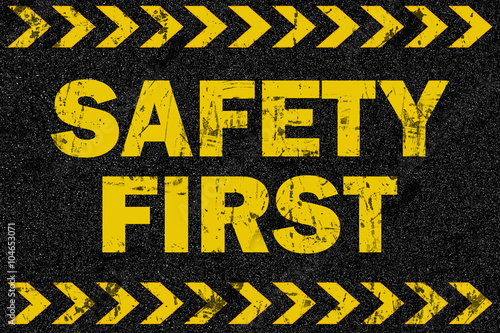 Safety first word on grunge background photo