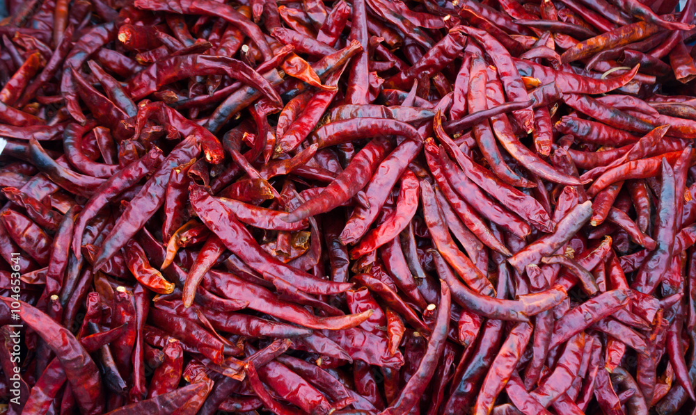 Dried chili peppers background. Many red hot pigments chile wallpaper, the combined or pile. Thai food seasoning. Close up and macro Dried chili peppers background. Many red hot pigments chile wallpaper, the combined or pile. Thai food seasoning. Close up and macro
