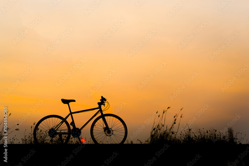 Obraz premium Sunset silhouette and bicycle on beautiful sky
