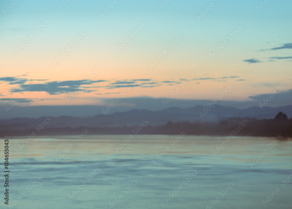 Fototapeta premium Blurry sunset sky over the river