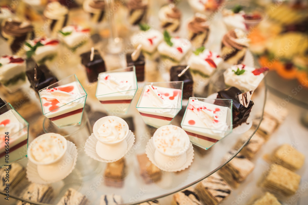 Different delicious desserts and cakes on the buffet table