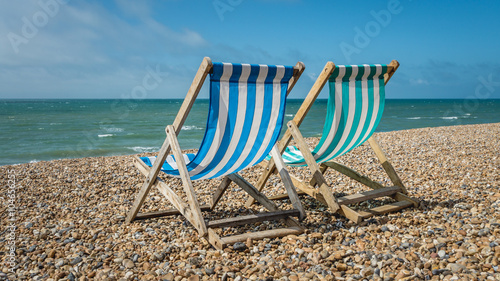 Deck chairs on a pebble beach