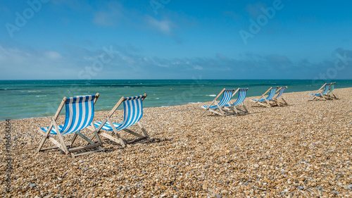 Deck chairs on a pebble beach