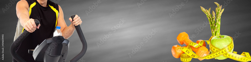 Man exercising on elliptical trainer.