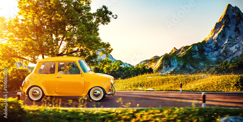 Fototapeta Naklejka Na Ścianę i Meble -  Cute little retro car goes by wonderful countryside road at sunset