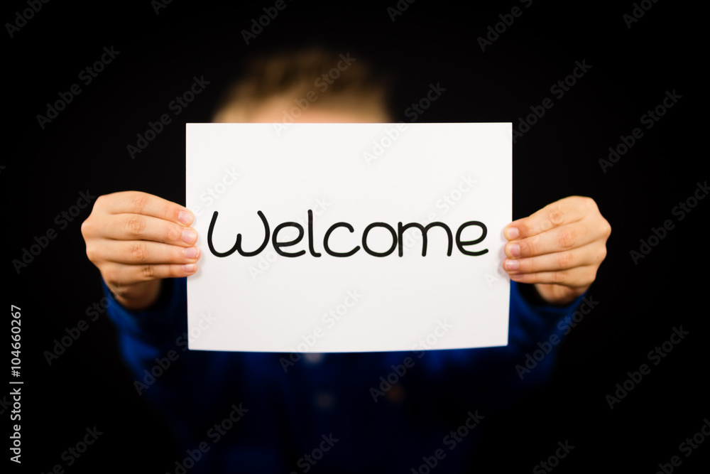 Child holding Welcome sign Child holding Welcome sign