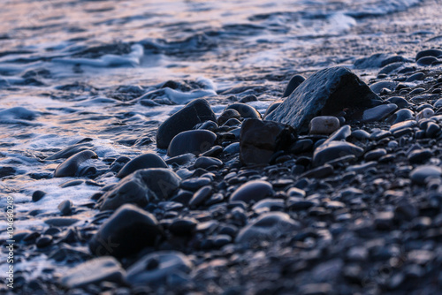 Pebbles on the sea shore at sunset