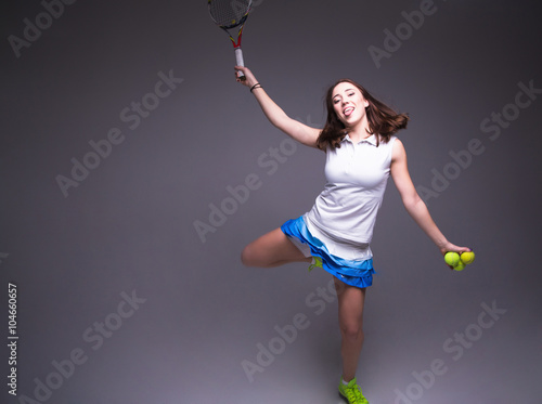 Healthy sporty girl with tennis racket and ball