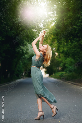 Young Woman Dancing on the Road