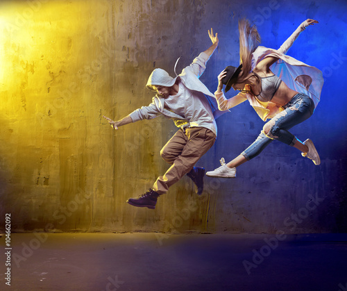 Fototapeta Naklejka Na Ścianę i Meble -  Stylish dancers fancing in a concrete area