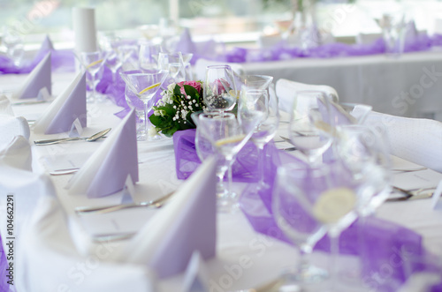 Wedding Table Setup with Flower, cloth napkins and glasses

