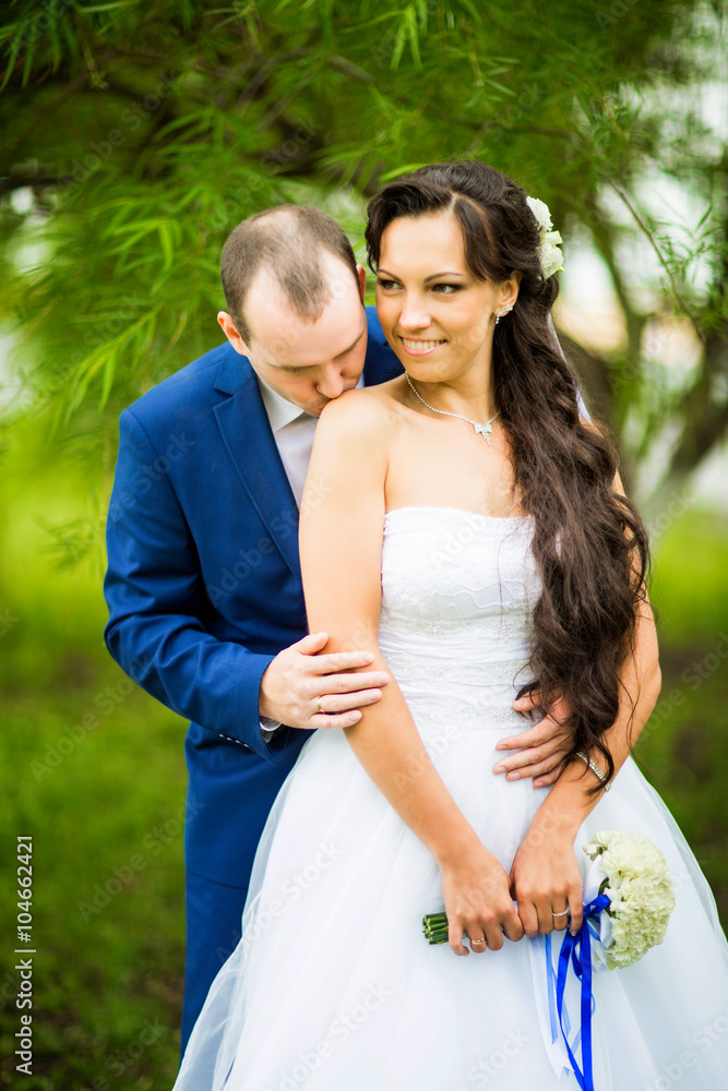 Young elegant and hearty wedding couple in love