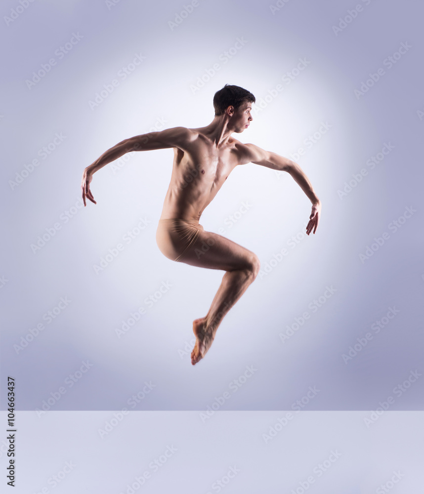 Athletic ballet dancer performing in a studio Athletic ballet dancer performing in a studio
