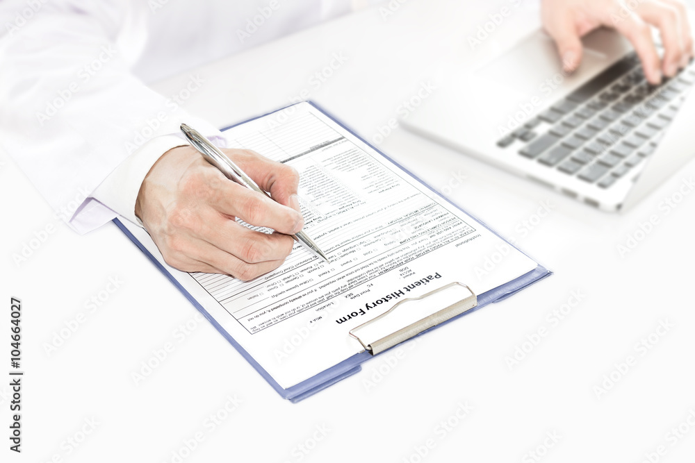 Selective focus at hand of Doctor checking new patient history f Selective focus at hand of Doctor checking new patient history f