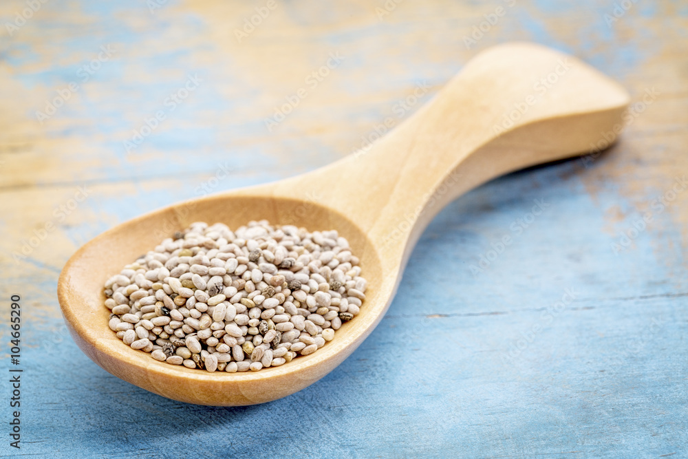 chia seeds on wooden spoon chia seeds on wooden spoon