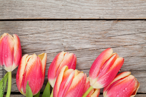 Colorful tulips on wooden table