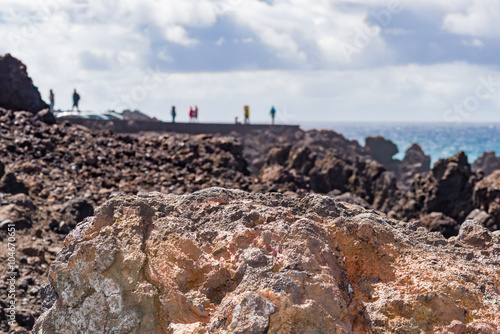 Blurred people at Los Hervideros coastline in Lanzarote Canary Islands A stretch of bizarre-shaped cliffs and underwater caves produced by the solidification of lava and erosion