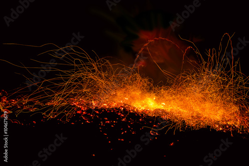 Sparks from the fire embers explosion on a black background