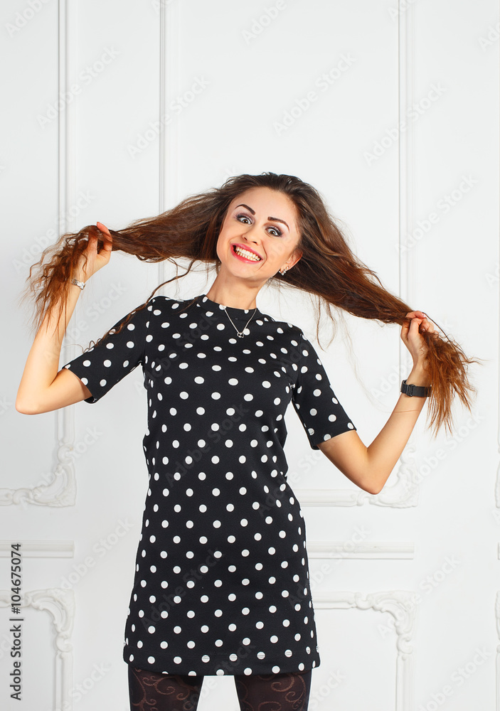 Young attractive woman in black dress smiling
