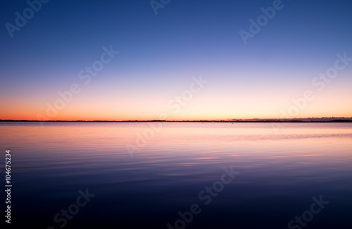 Canvas Print First light of day creates dramatic colors in the sky over Ocean.