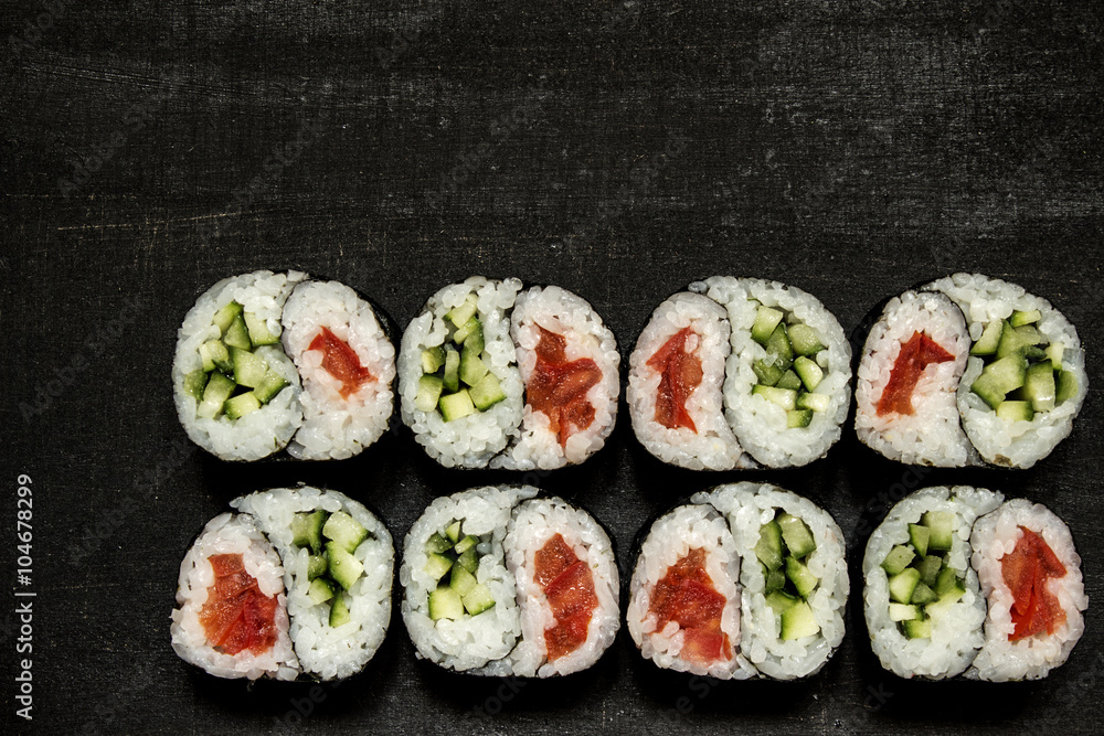 Rolls Yin-Yang with cucumber and tomato on a black background Rolls Yin-Yang with cucumber and tomato on a black background