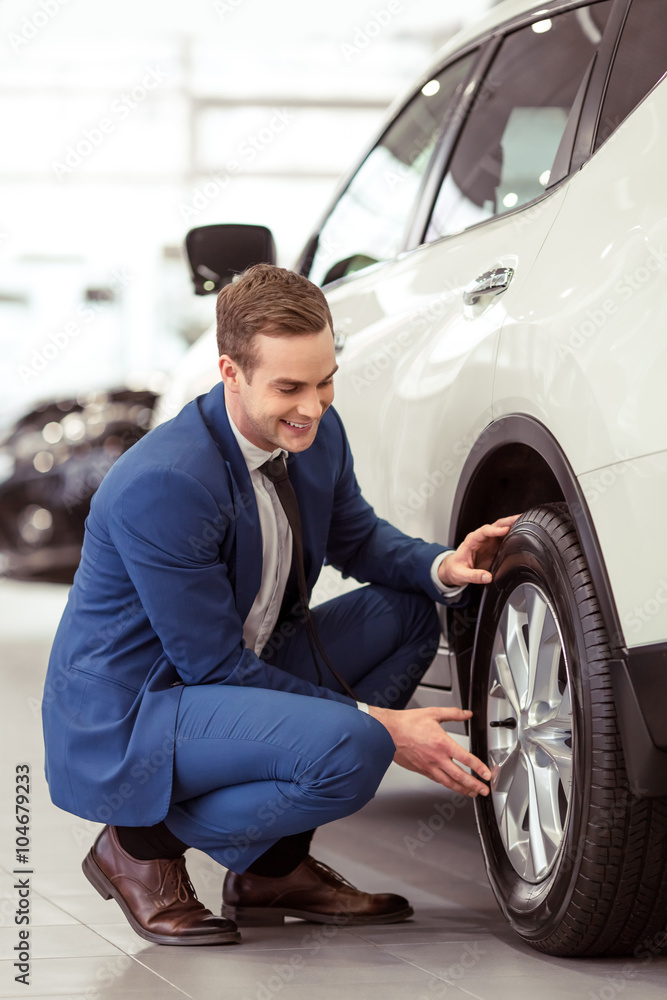 Young businessman in motor show Young businessman in motor show