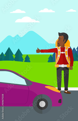 Young man hitchhiking.