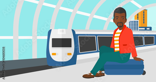 Man sitting on railway platform.