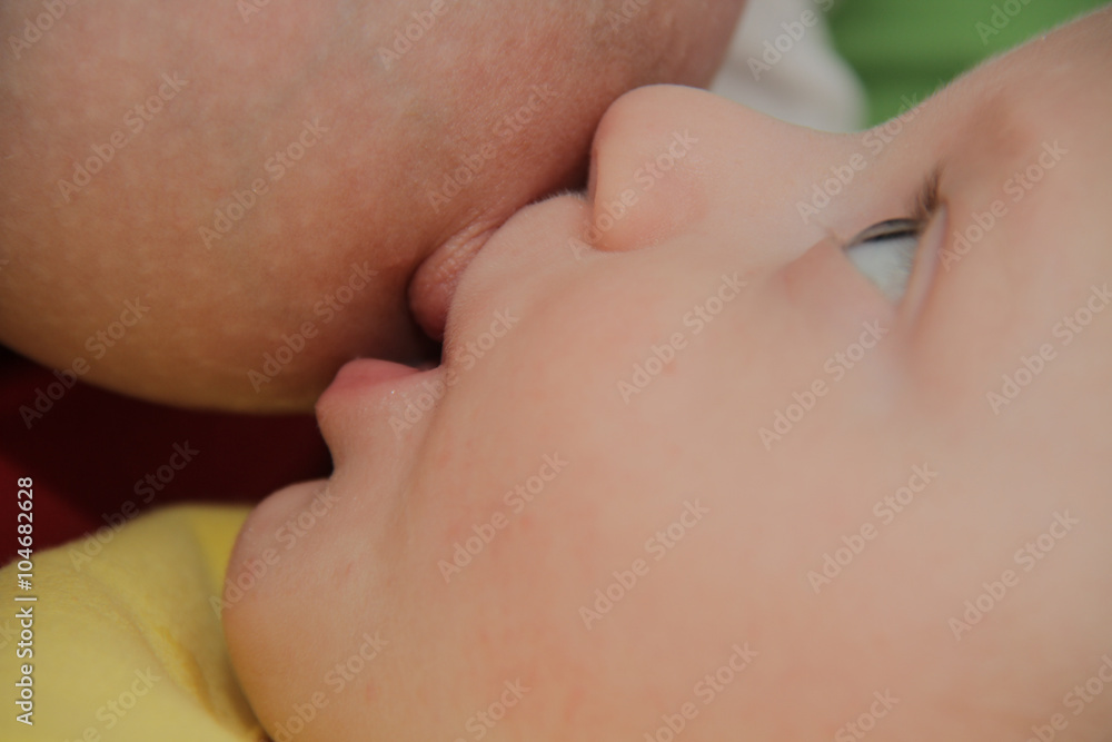 Mom breastfeeding baby boy with breast milk Mom breastfeeding baby boy with breast milk