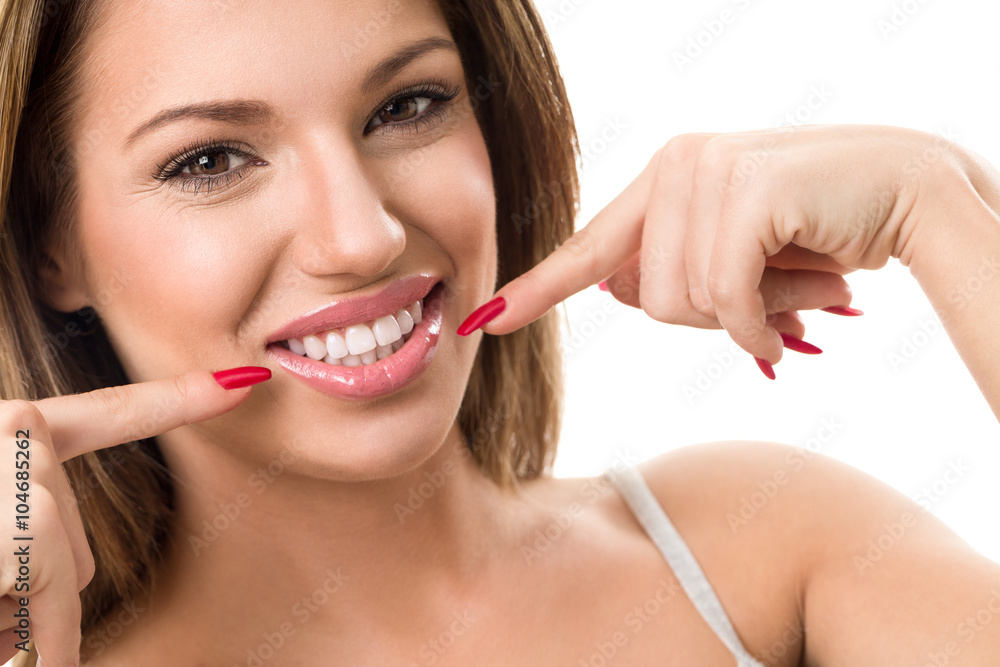Happy girl with beautiful smile pointing in her teeth Happy girl with beautiful smile pointing in her teeth