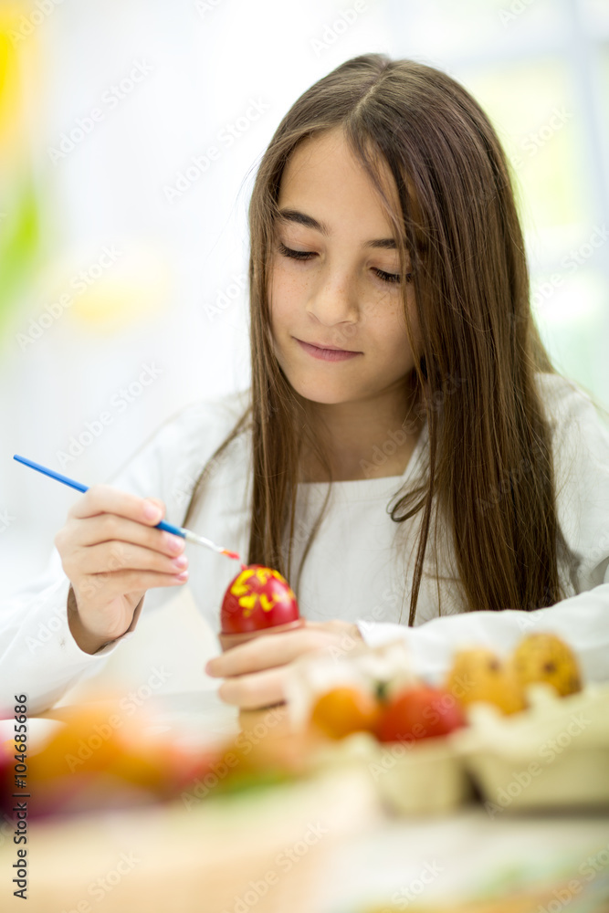 happy little girl painting Easter eggs happy little girl painting Easter eggs