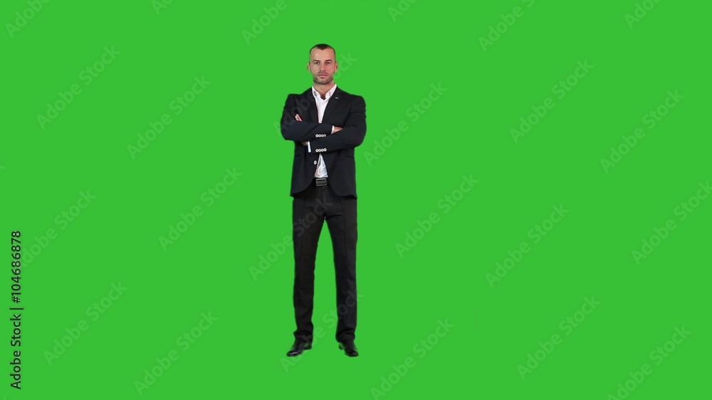 A man in a suit on a green background A man in a suit on a green background