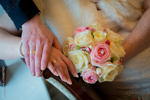 Hands and rings with beautiful wedding bouquet