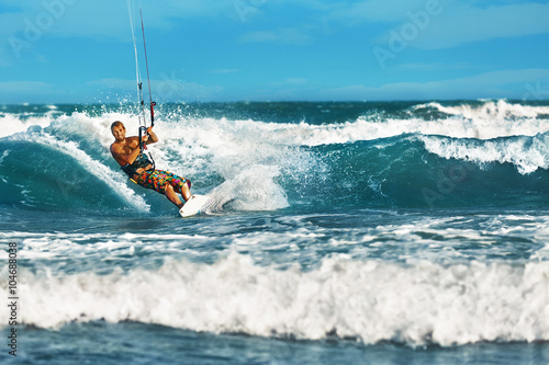 Water Sports. Kiteboarding, Kitesurfing. Surfer Man Surfing On Waves In Ocean, Sea. Extreme Sport Action. Recreational Sporting Activity. Healthy Active Lifestyle. Summer Fun Adventure. Hobby © puhhha
