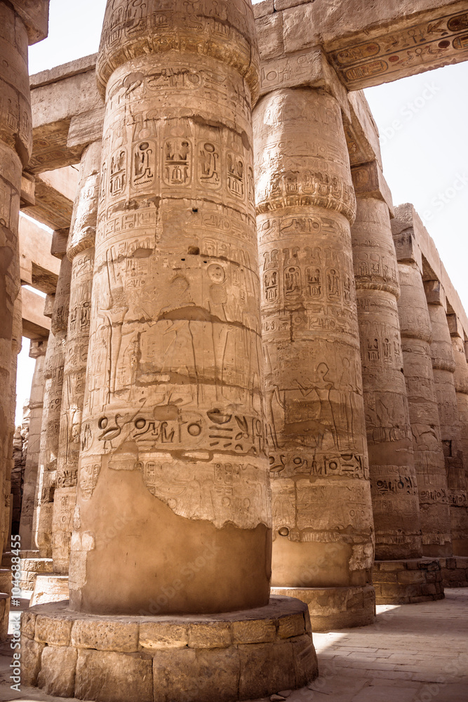 A sandstone column in Egypt. columns covered in hieroglyphics A sandstone column in Egypt. columns covered in hieroglyphics
