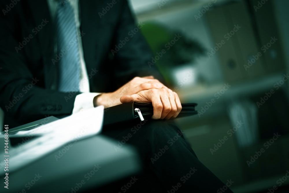 confident businessman with a folder in his hands in the office