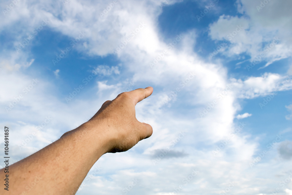 Man pointing his hand and cloud sky background Man pointing his hand and cloud sky background