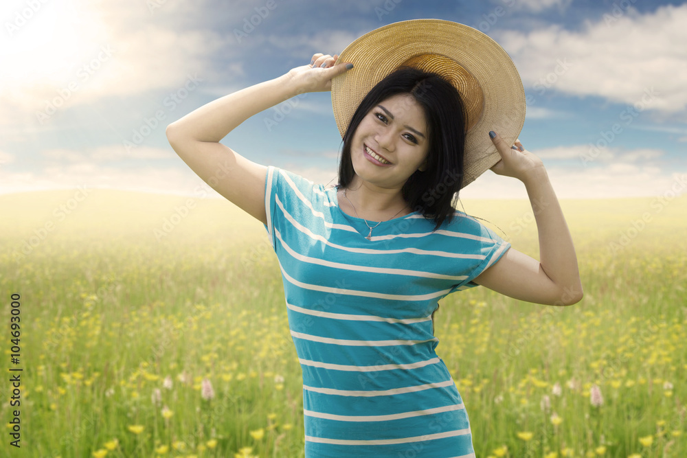 Pretty female model with hat on meadow