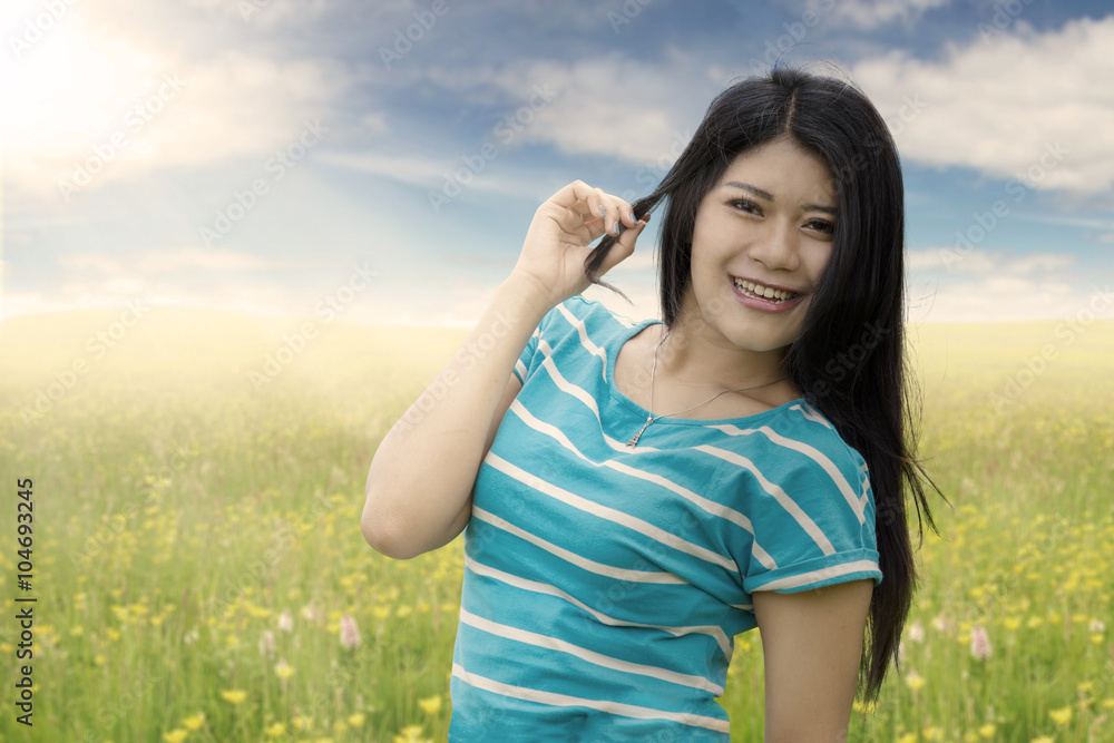 Woman with long hair smiling on meadow Woman with long hair smiling on meadow