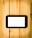 tablet on wooden background in warm tone 