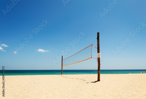 Volleyball net on the beach and tropical sea