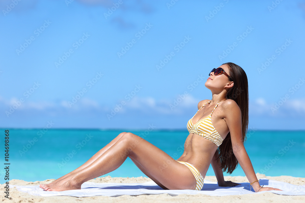 Beach sunglasses woman sun tanning in sexy bikini. Full body girl lying down getting a suntan on wearing eyewear. Skincare solar uv rays protection concept. foto de Stock | Adobe Stock