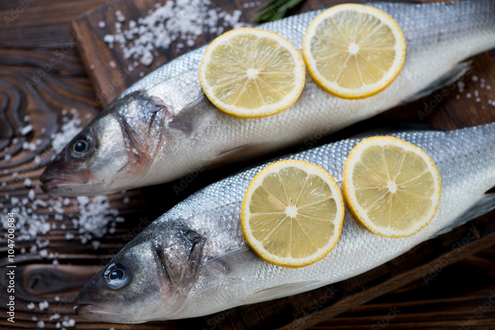 Close-up of fresh uncooked seabass with lemon and sea salt Close-up of fresh uncooked seabass with lemon and sea salt