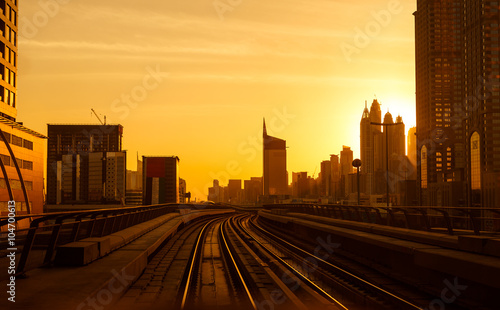 Modern architecture of Dubai, UAE, by sunset seen from a metro car. Traveling in Dubai, UAE.