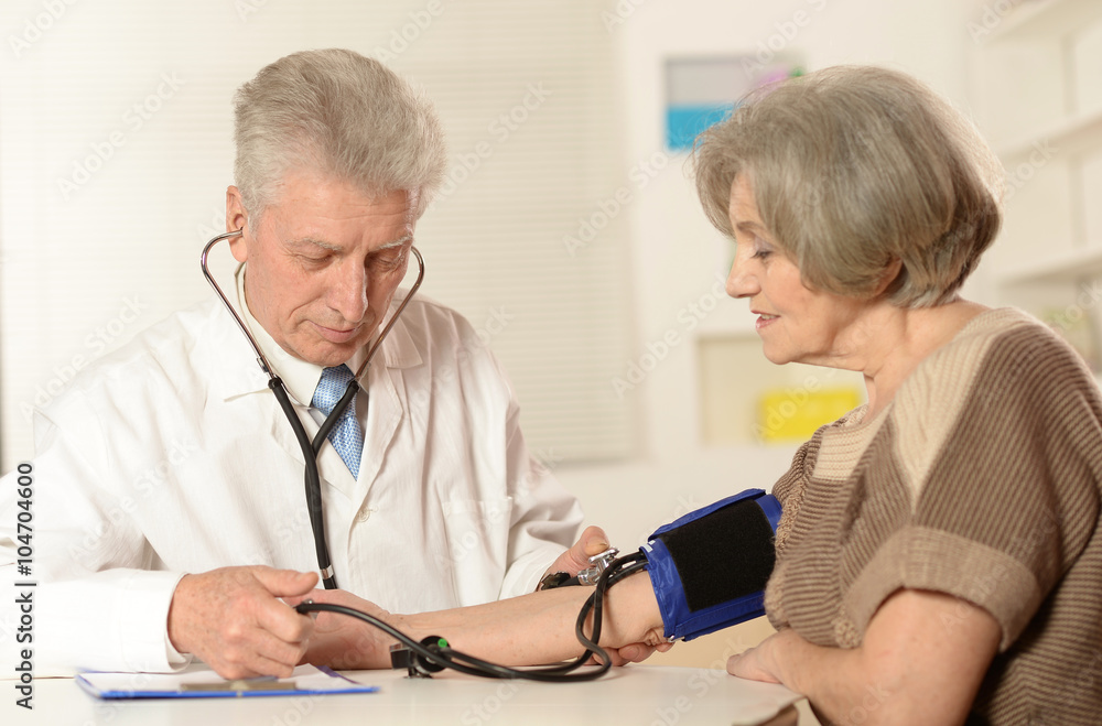 Elderly doctor measuring Elderly doctor measuring