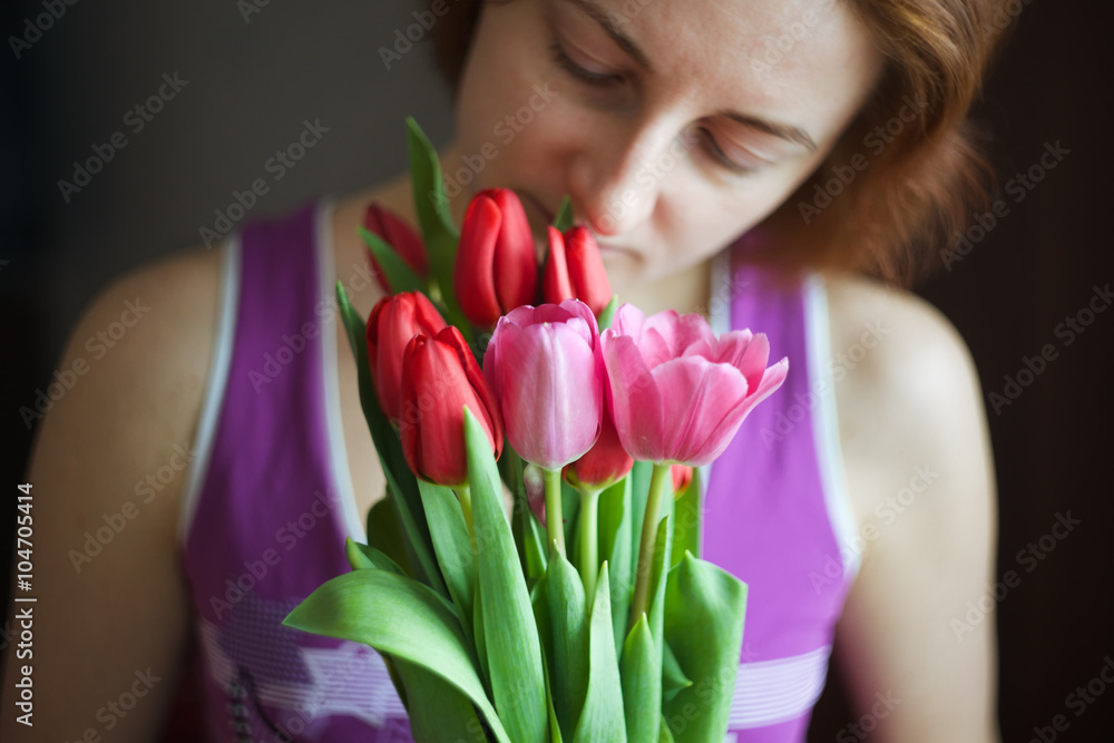 Bunch of tulips in woman hands. The holiday of spring and love. Bunch of tulips in woman hands. The holiday of spring and love.