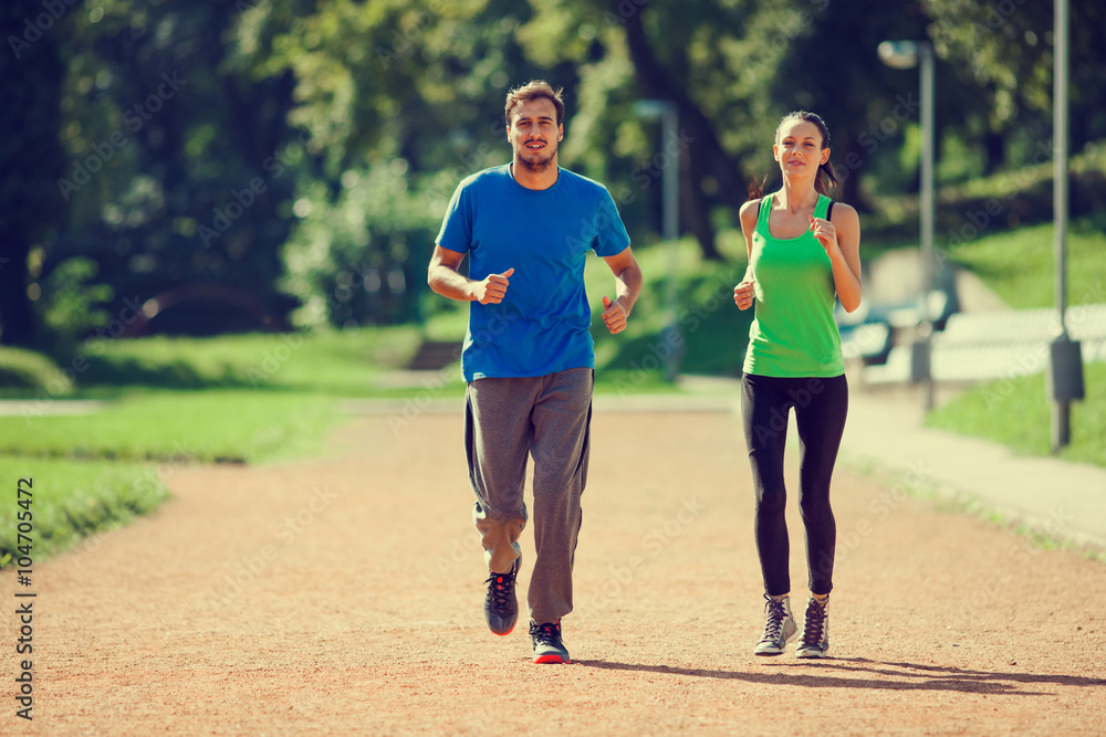 Young couple jogging, intentionally toned image. Young couple jogging, intentionally toned image.