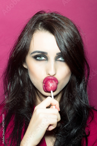 Girl licking lollipop