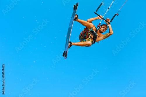 Kiteboarding, Kitesurfing. Water Sports. Professional Kite Surfer In Action In Air. Extreme Sport In Ocean. Healthy Active Lifestyle. Recreational Sporting Activity. Summer Fun, Hobby. Adrenaline.